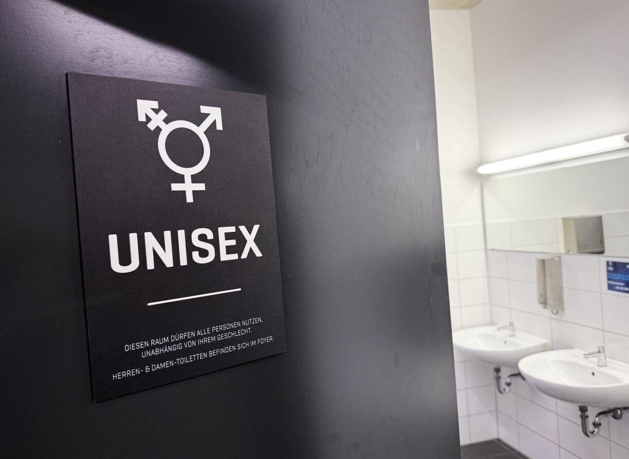 A sign with the pictogram "Unisex" seen at the entrance to a toilet in a sports hall in Germany.