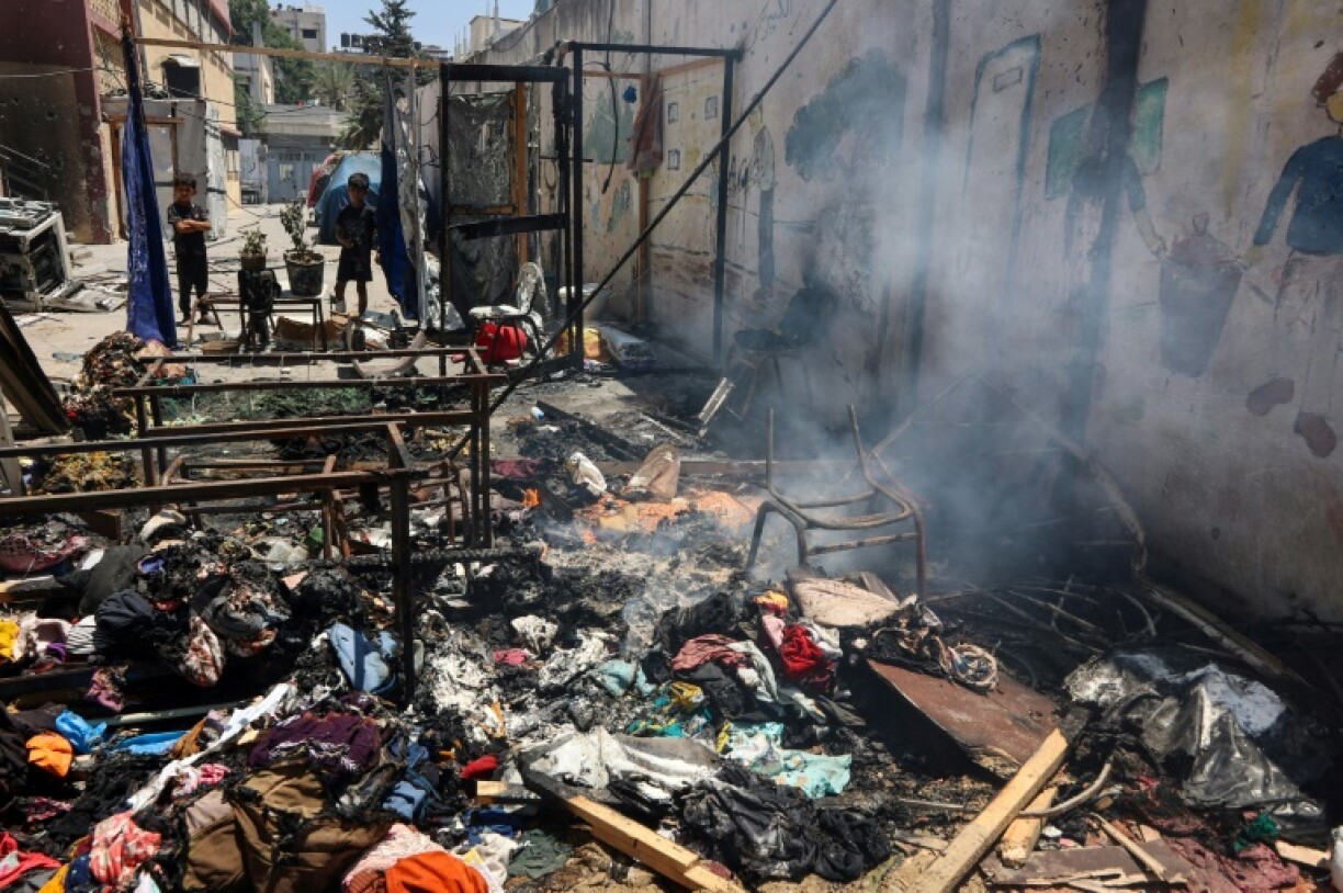 Piles of debris smouldered in the Gaza City school compound hit on Thursday