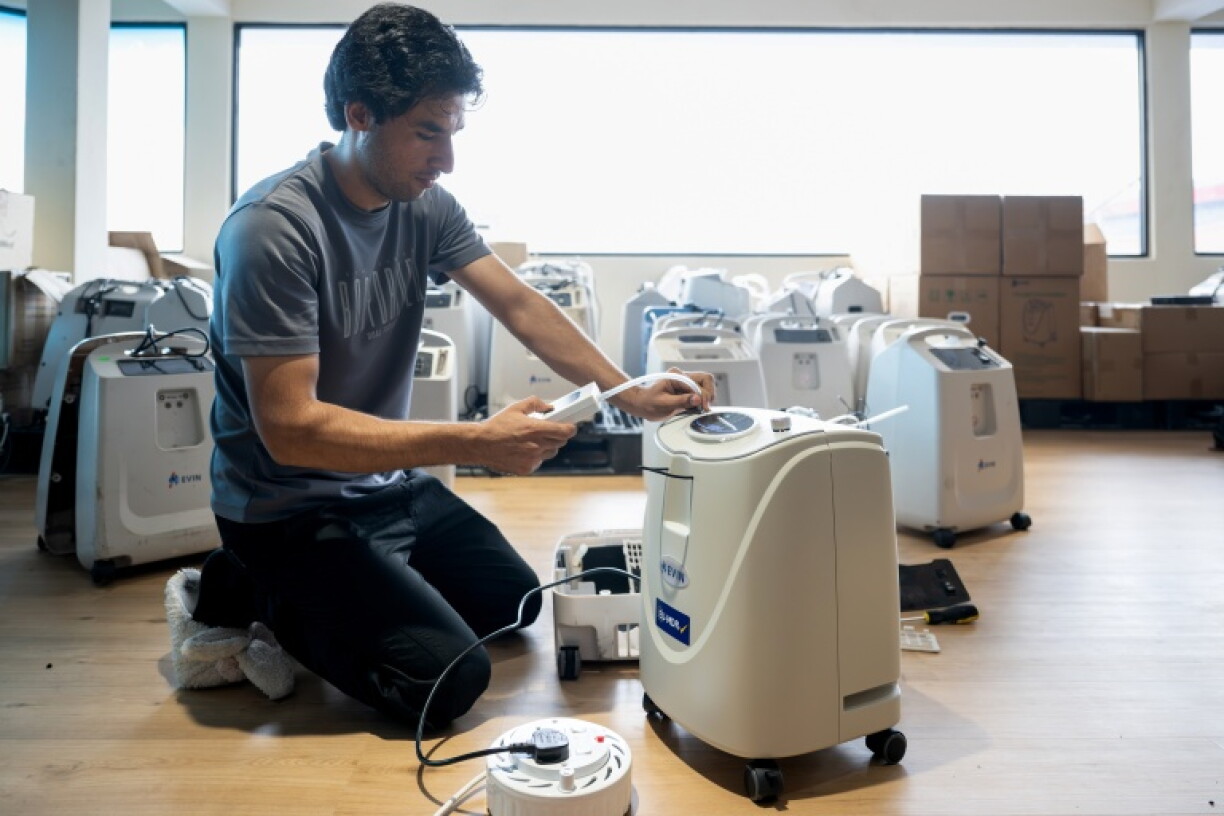 A technician inspects a new oxygen concentrator before it is delivered to a customer at a medical supply warehouse in Kuala Lumpur on October 15, 2026