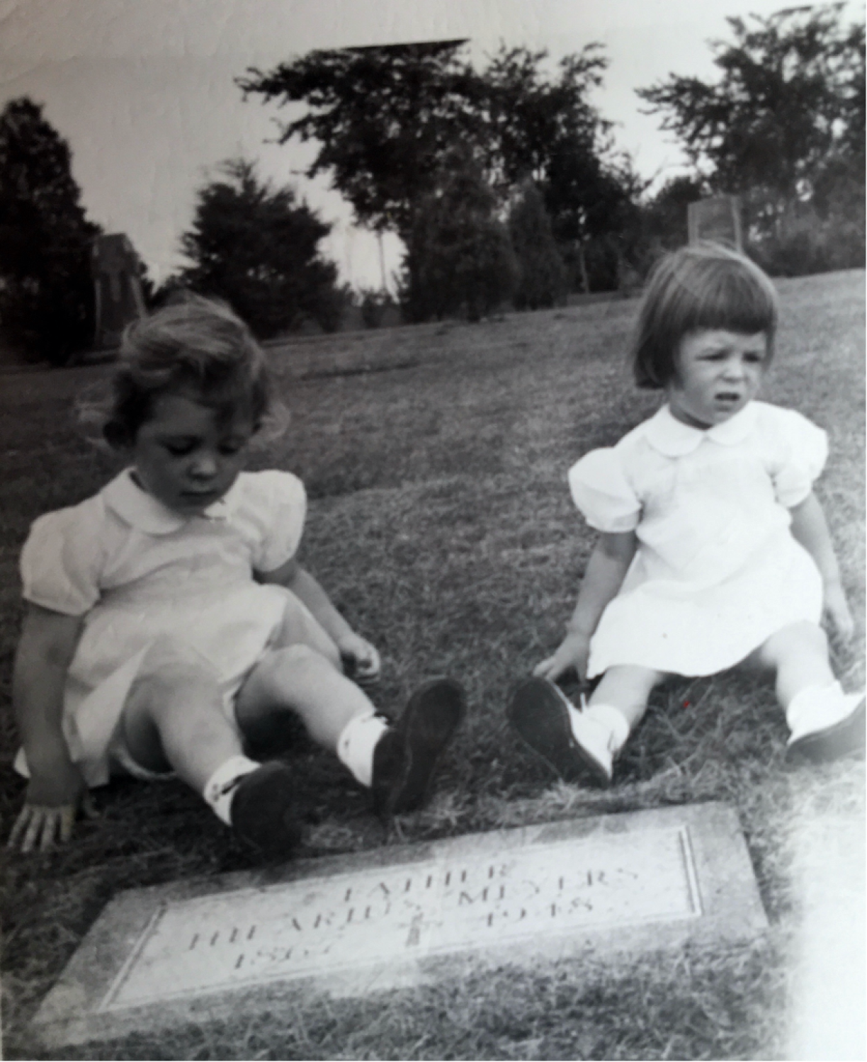Mary (L) and Nancy Meyers at their grandfather Hilarius' grave.