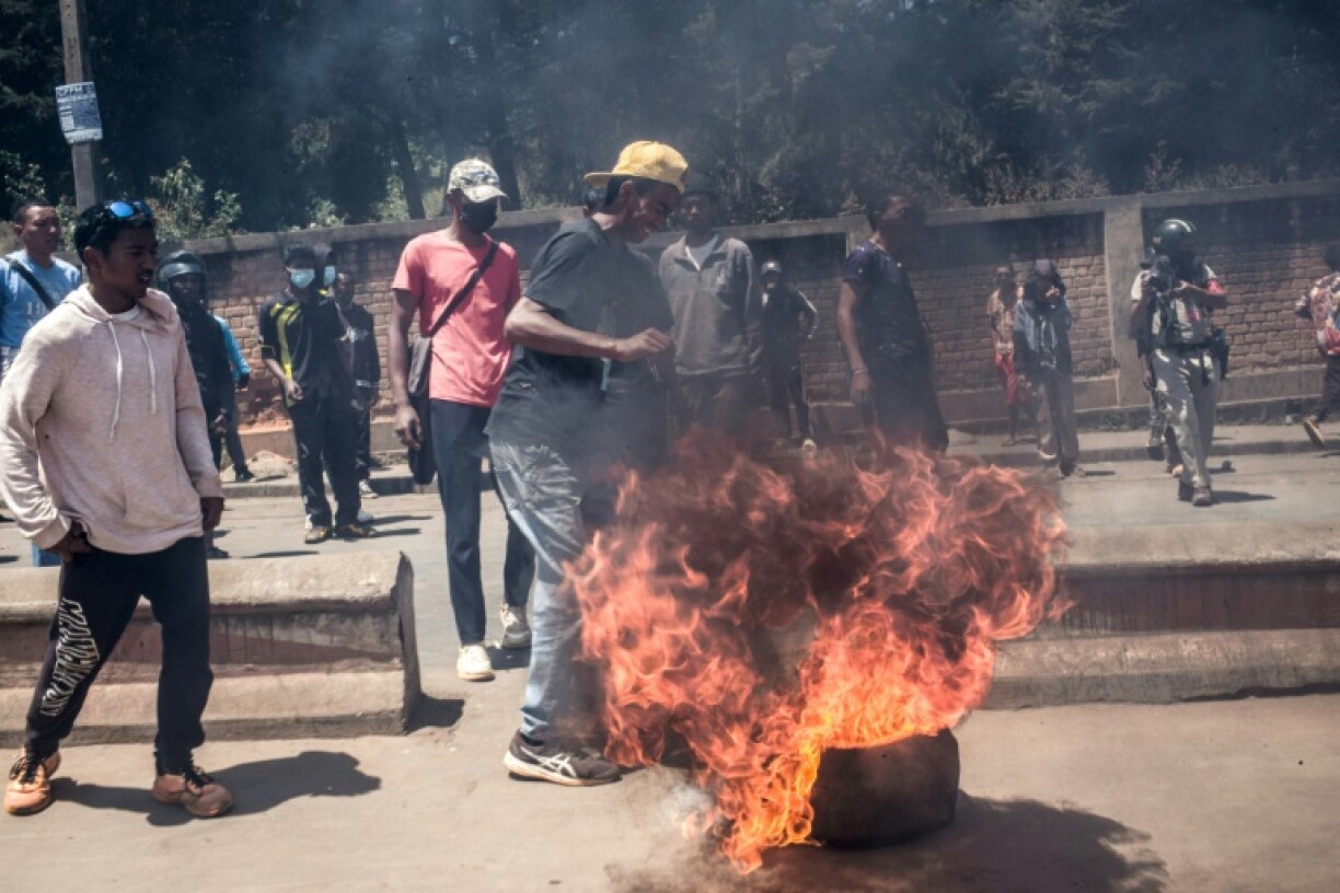 Protesters erect a burning barricade in Antananarivo as authorities respond with tear gas