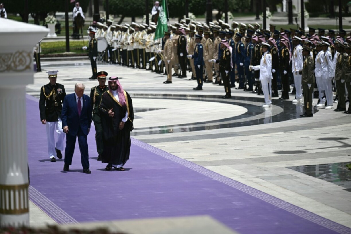 Saudi Crown Prince Mohammed Bin Salman and US President Donald Trump review the honour guard at the Royal Court in Riyadh