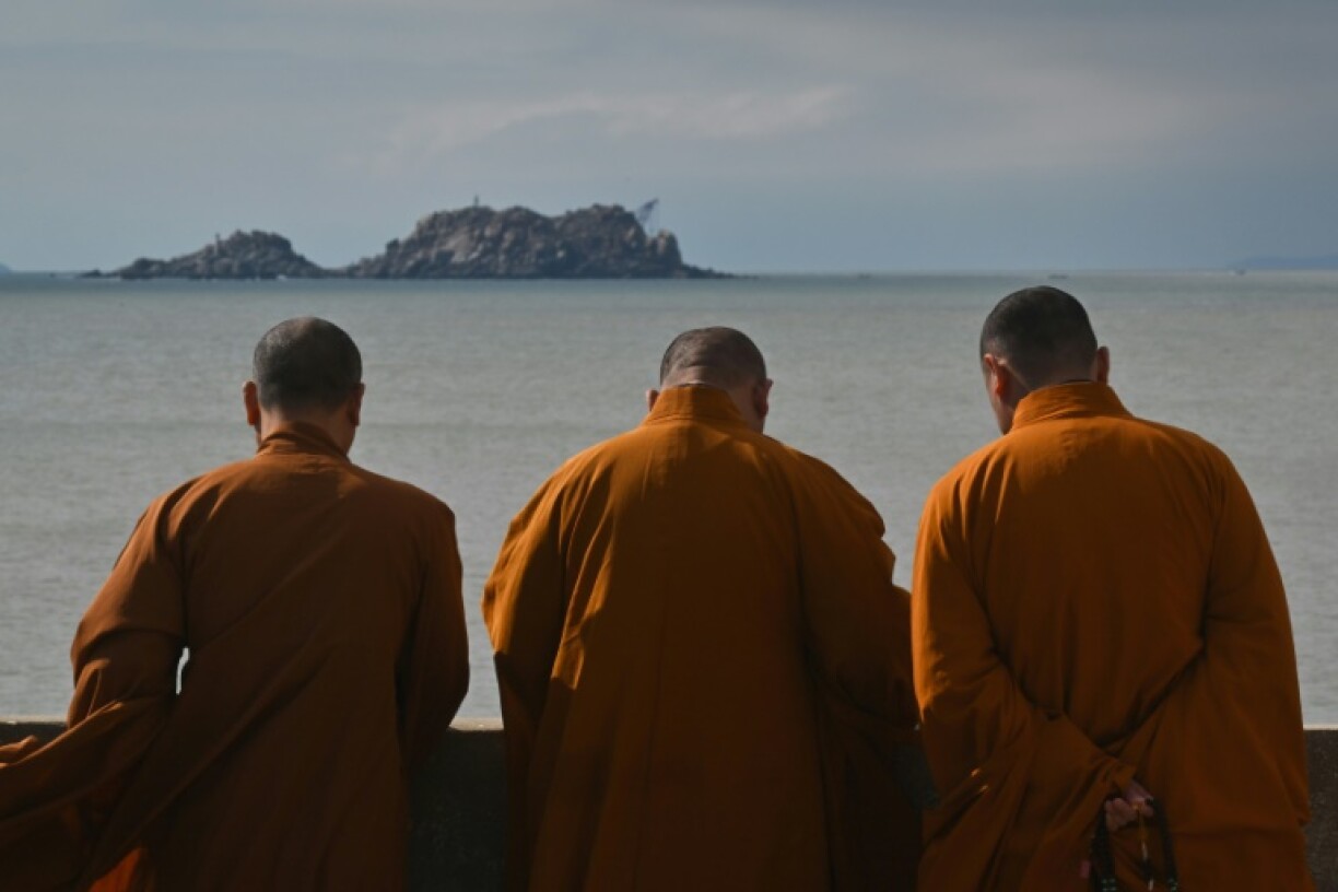 Buddhist monks look over the sea at a temple on Pingtan island, the closest point in China to Taiwan's main island