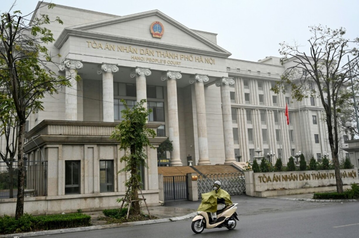 A man rides a motorbike past the Hanoi People's Court where the trial of leading independent journalist Huy Duc lasted just a few hours