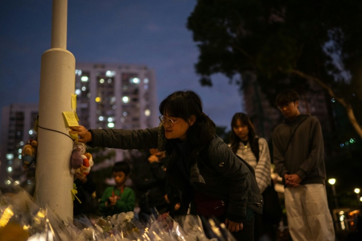 Queues of mourners stretched for hundreds of metres as people arrived at the charred ruins of a residential complex to pay their respects after at least 128 people were killed in Hong Kong's worst blaze in decades