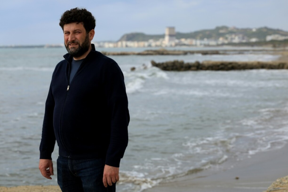 Hotel manager Edvin Dule on a disappearing beach near Durres