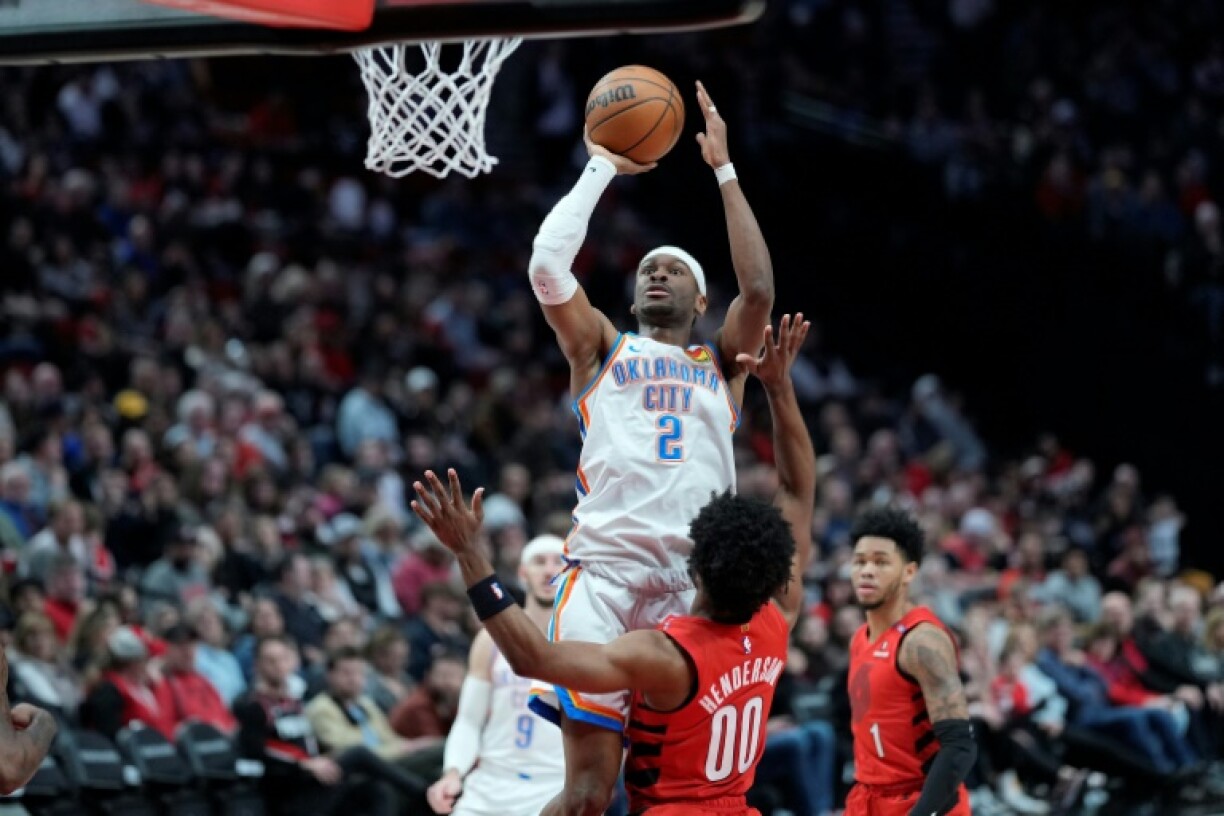 Oklahoma City's Shai Gilgeous-Alexander rises for a shot over Scoot Henderson in the Thunder's NBA victory over the Portland Trail Blazers