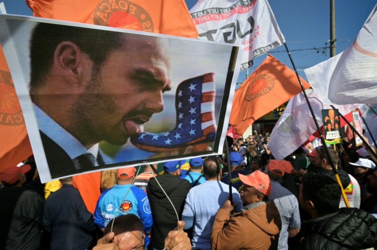 A protester with a poster depicting Bolsonaro licking a US-flagged boot