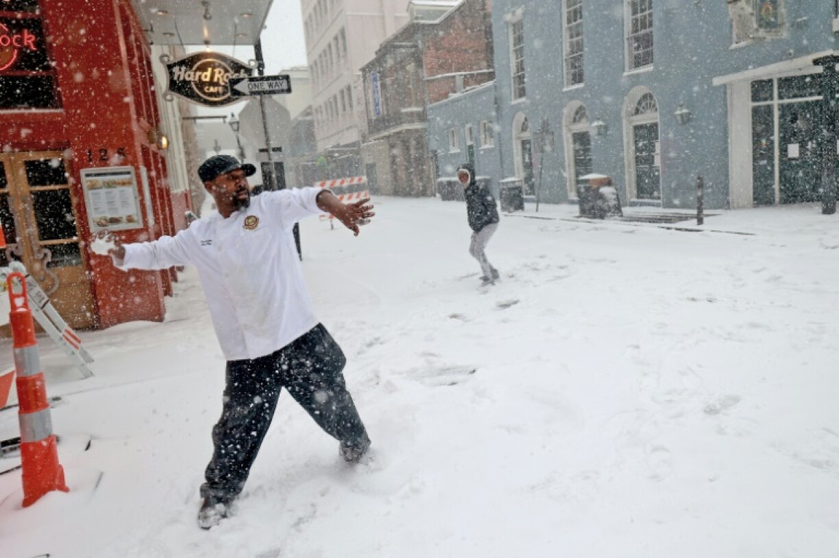 Sous chef Eric Walker engages in a snowball fight outside the Bourbon House Restaurant in the French Quarter in New Orleans, Louisiana, where a rare snow storm hammered the southern US city