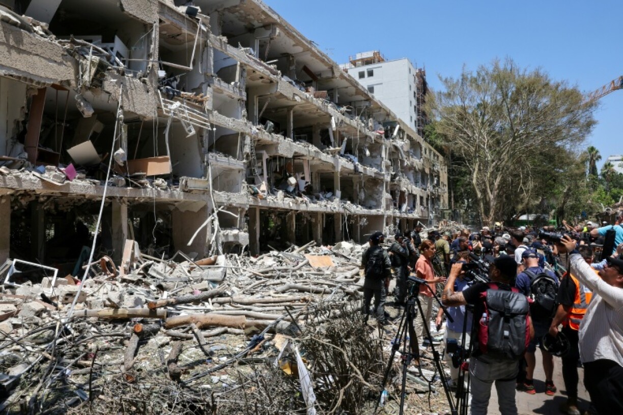 Israeli security forces and media gather at the site of an Iranian strike that hit a residential neighbourhood in the Ramat Aviv area in Tel Aviv on June 22, 2025