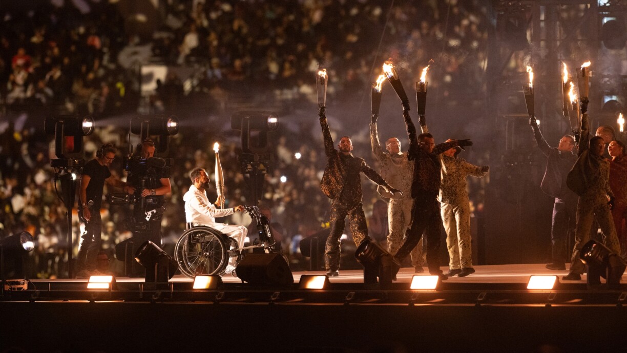 Torchbearer Michael Jeremiasz carries the Paralympic Flame during the opening ceremony of the Paris 2024 Summer Paralympic Games at Place de la Concorde in Parison 28 August 2024.