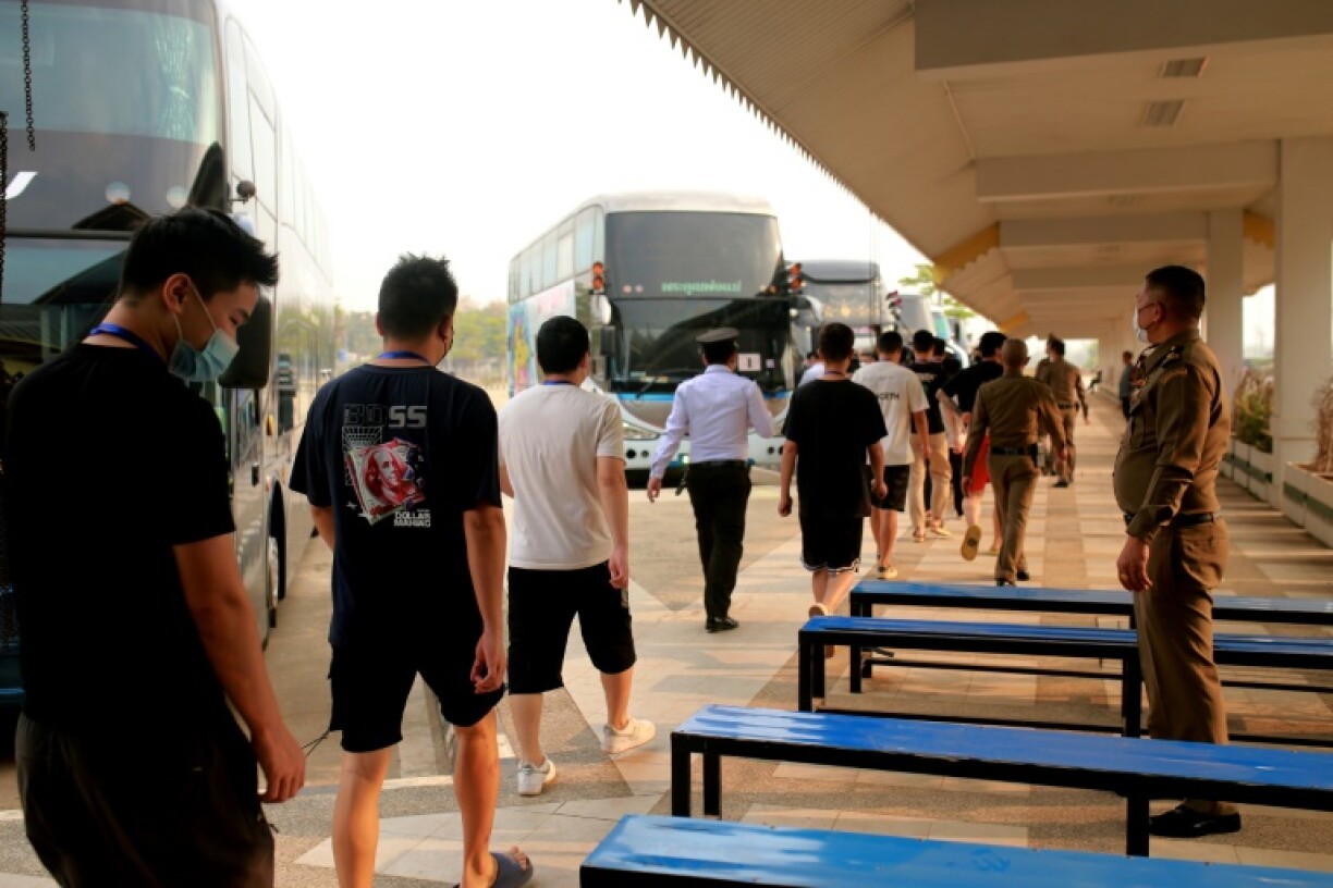 Alleged scam centre workers and victims from China arrive at the border checkpoint with Thailand in Myanmar's eastern Myawaddy township on February 20