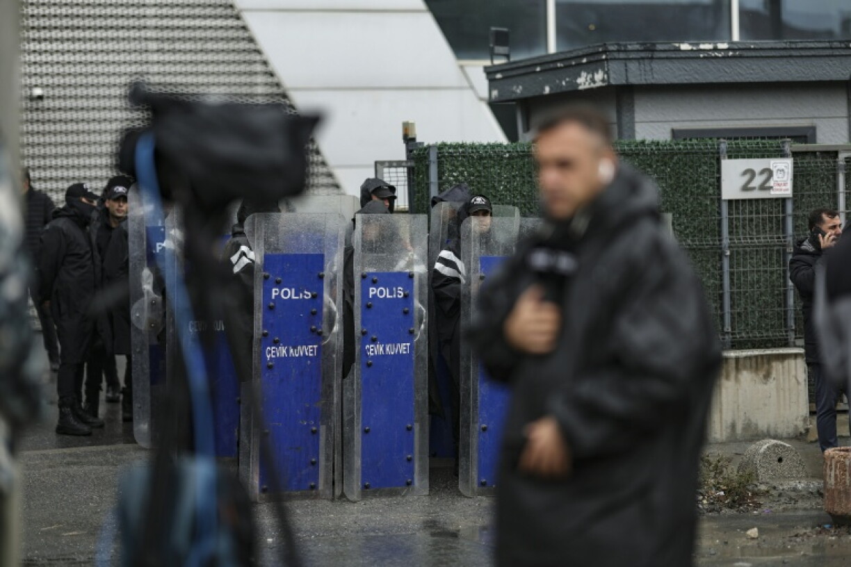 Turkish riot police stand guard outside pro-opposition Halk TV in Istanbul during a raid on the channel's headquarters