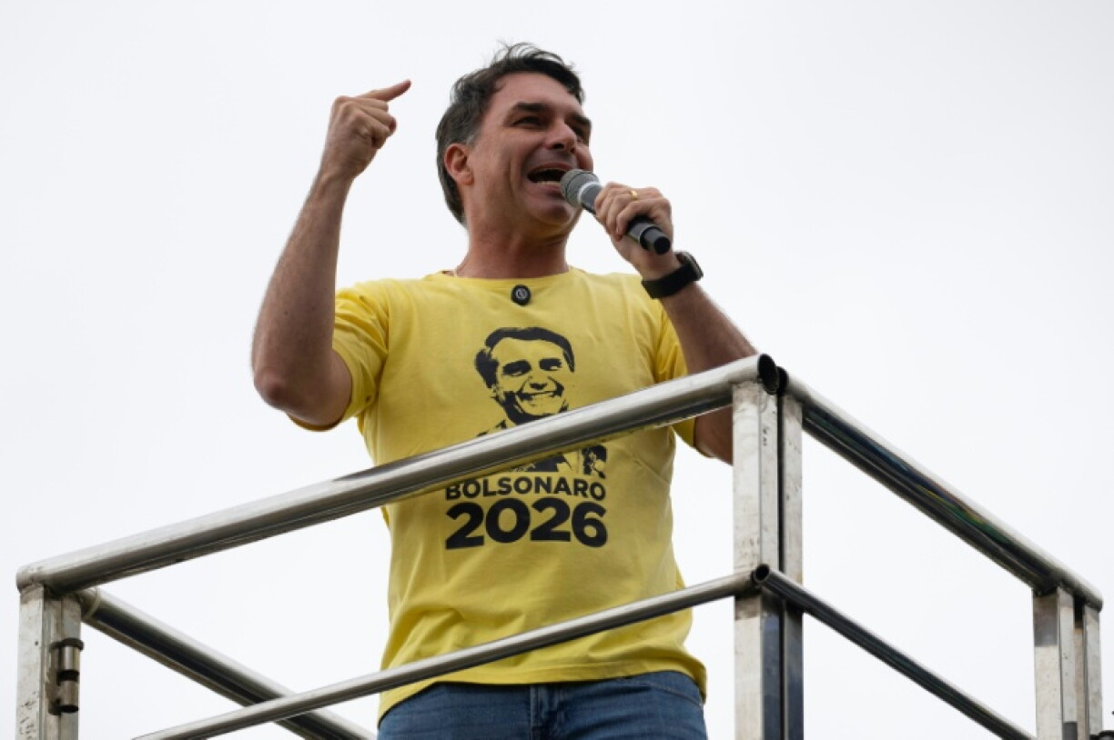 Senator Flavio Bolsonaro, pictured wearing a photo of his father's face, has struggled to break free of the shadow of the former president