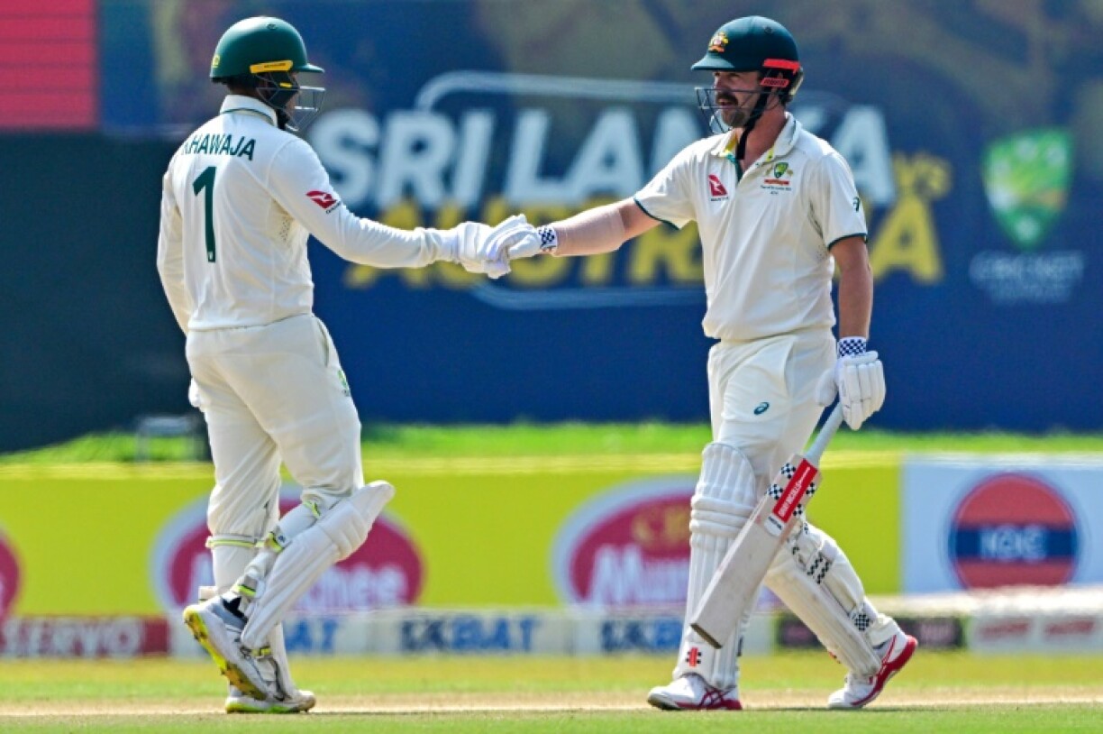 Australia's Usman Khawaja (left) and teammate Travis Head bump fists on the fourth day of the second Test against Sri Lanka in Galle