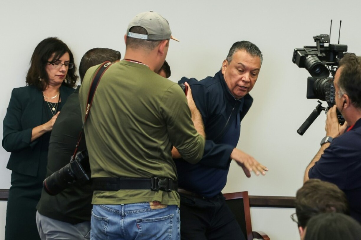 US Senator Alex Padilla, Democrat from California, is removed from the room after interrupting a news conference with Department of Homeland Security Secretary Kristi Noem in Los Angeles on June 12, 2025