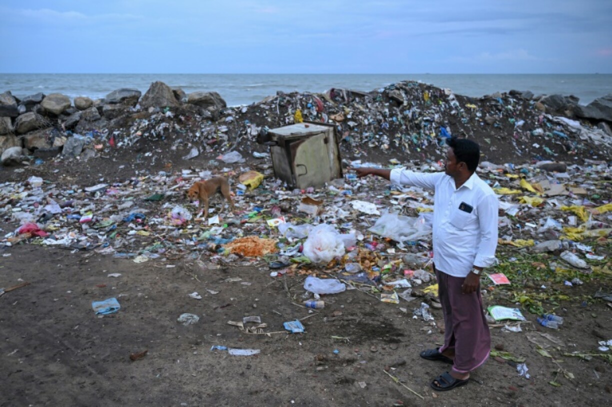 P. Mohan, a fisherman and 2004 tsunami victim, shows the former location of his house, which was swept away in the disaster