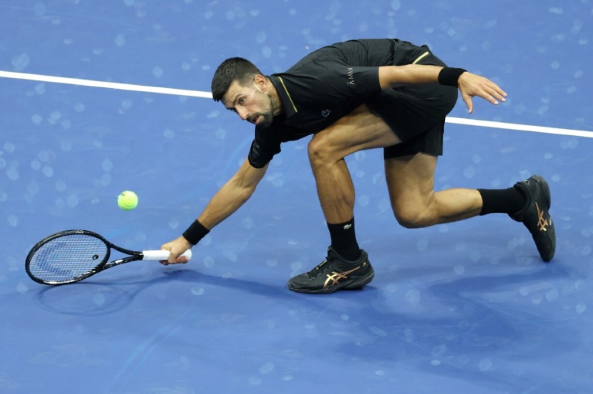 Serbia's Novak Djokovic scrambles to return during his US Open first round win over teenager Learner Tien