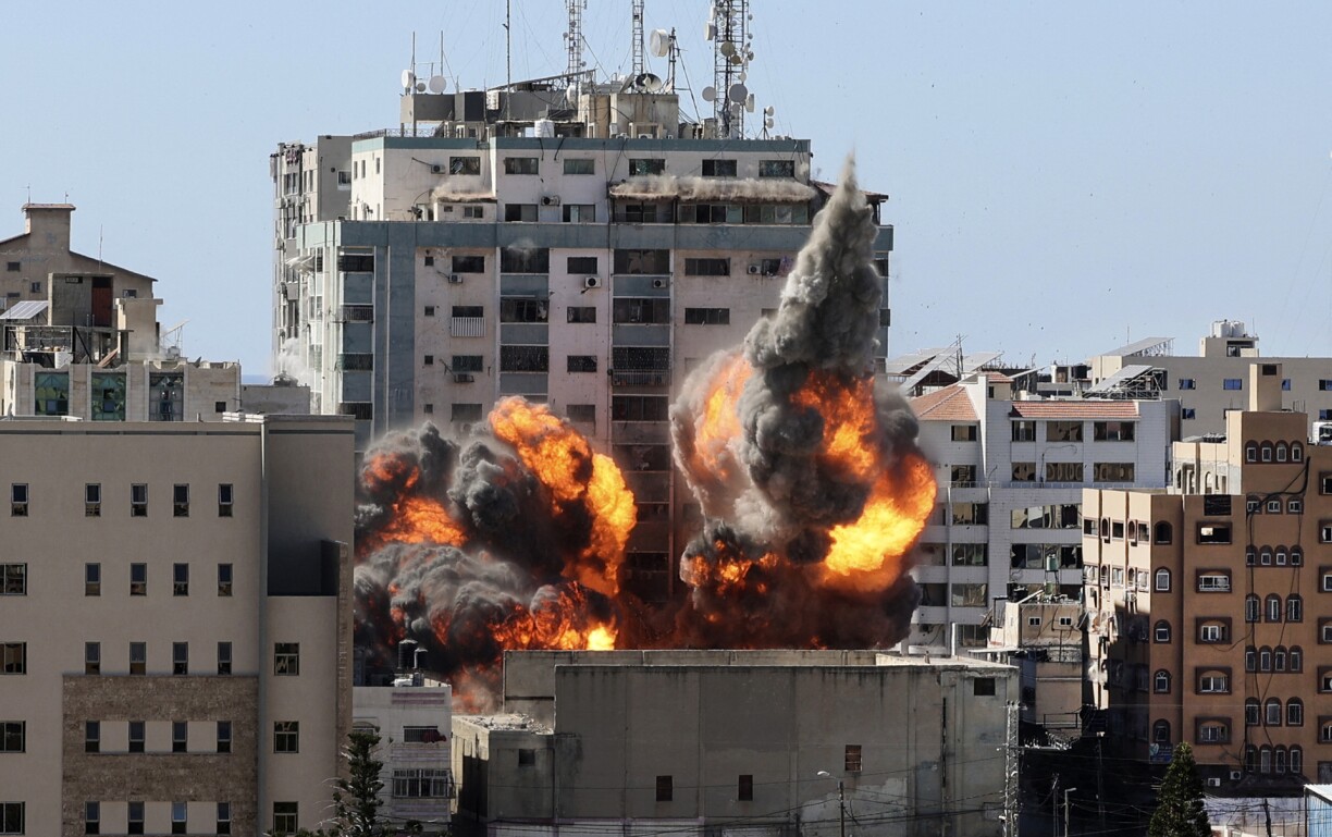 A ball of fire erupts from the Jala Tower as it is destroyed in an Israeli airstrike in Gaza city controlled by the Palestinian Hamas movement, on May 15, 2021.