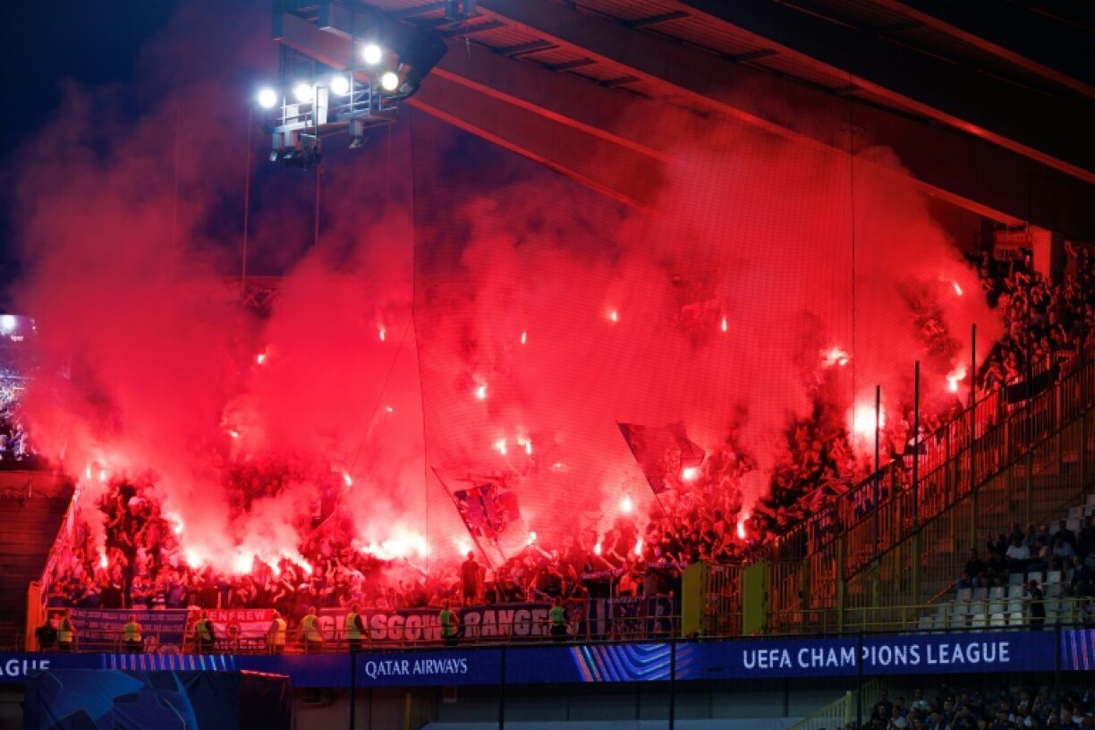 Rangers' supporters light flares during the Scottish club's Champions League play-off defeat against Club Brugge in Belgium