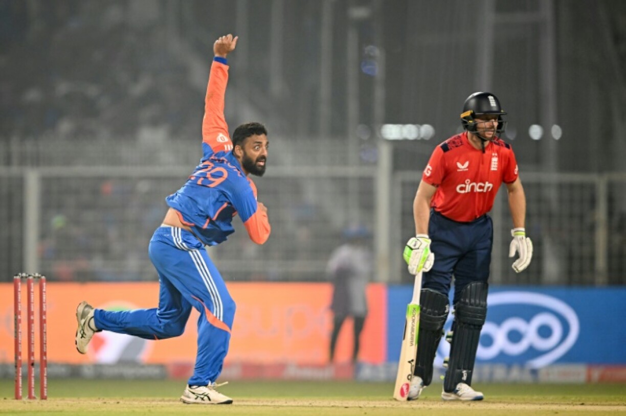 India's Varun Chakravarthy on his way to taking three wickets, including the crucial scalp of Jos Buttler (R)