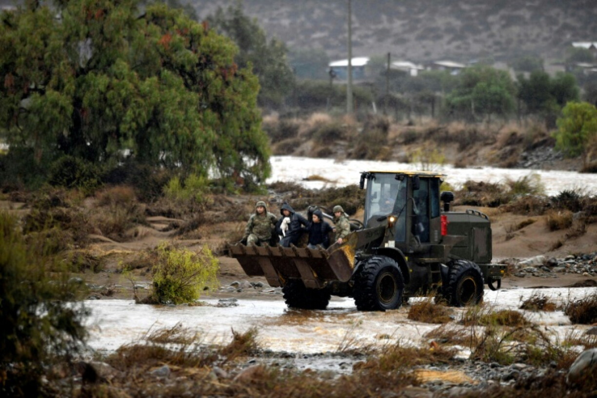 Members of the Chilean Army rescue residents stranded in a rural area of the Coquimbo region following heavy rainfall