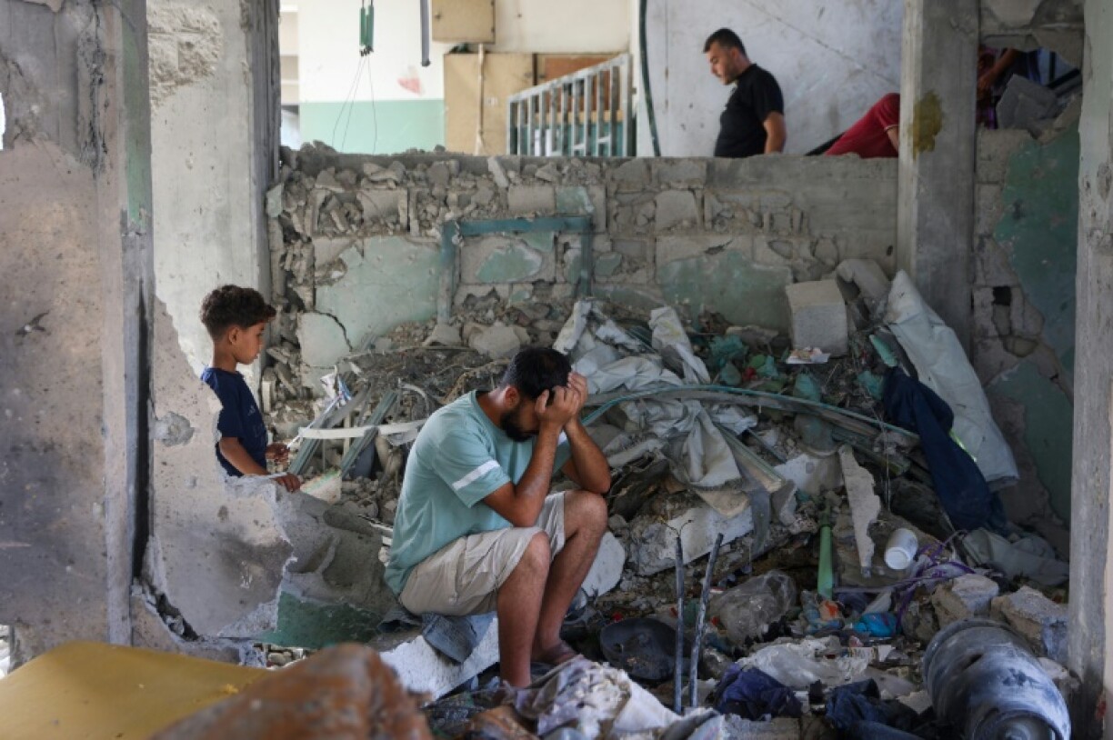 A man sits amid the rubble at the Fahmi Al-Jarjawi School in Gaza City