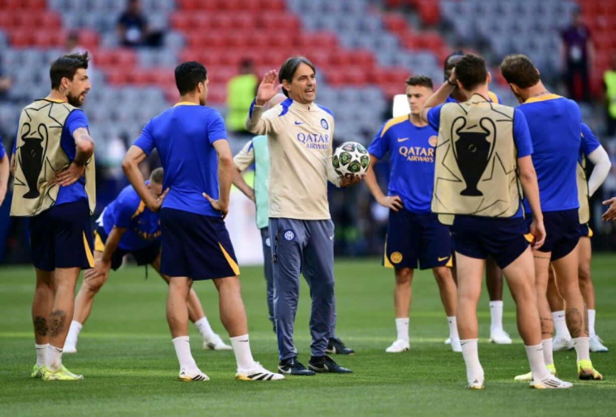 Inter coach Simone Inzaghi talks tactics with his players during training on Friday
