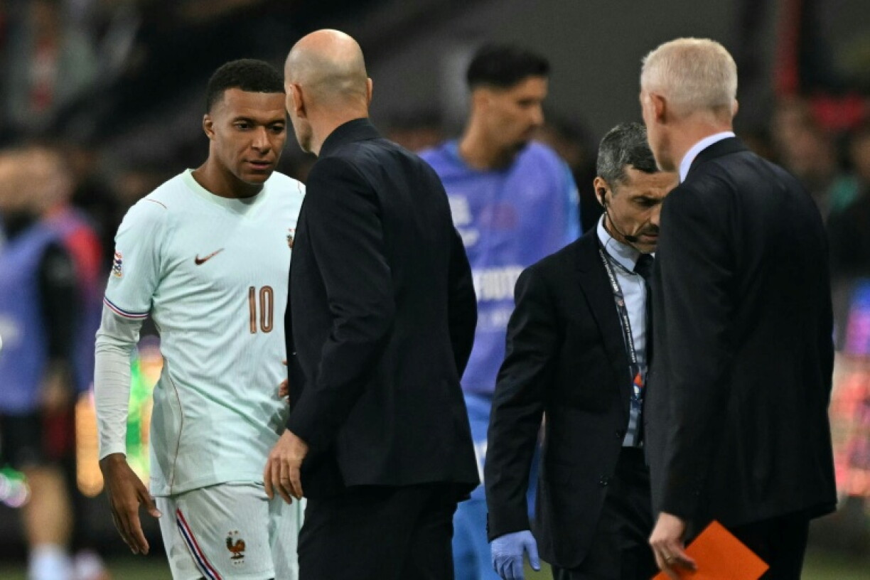 Kylian Mbappe walks off injured as coach Zinedine Zidane looks on during France's UEFA Nations League win in Turkey on Friday