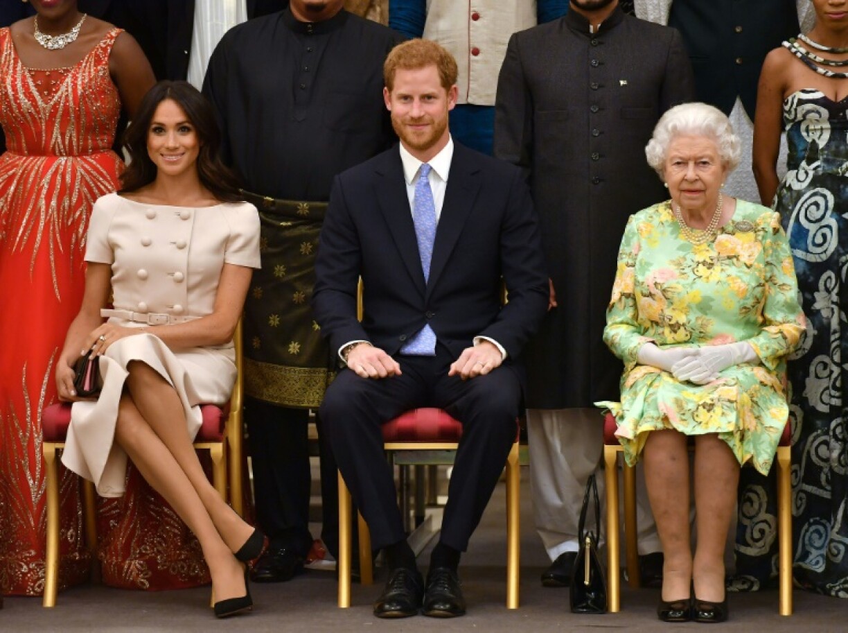 Meghan Markle, le prince Harry et la reine Elizabeth II à Bunckingham Palace, le 26 juin 2018, à Londres