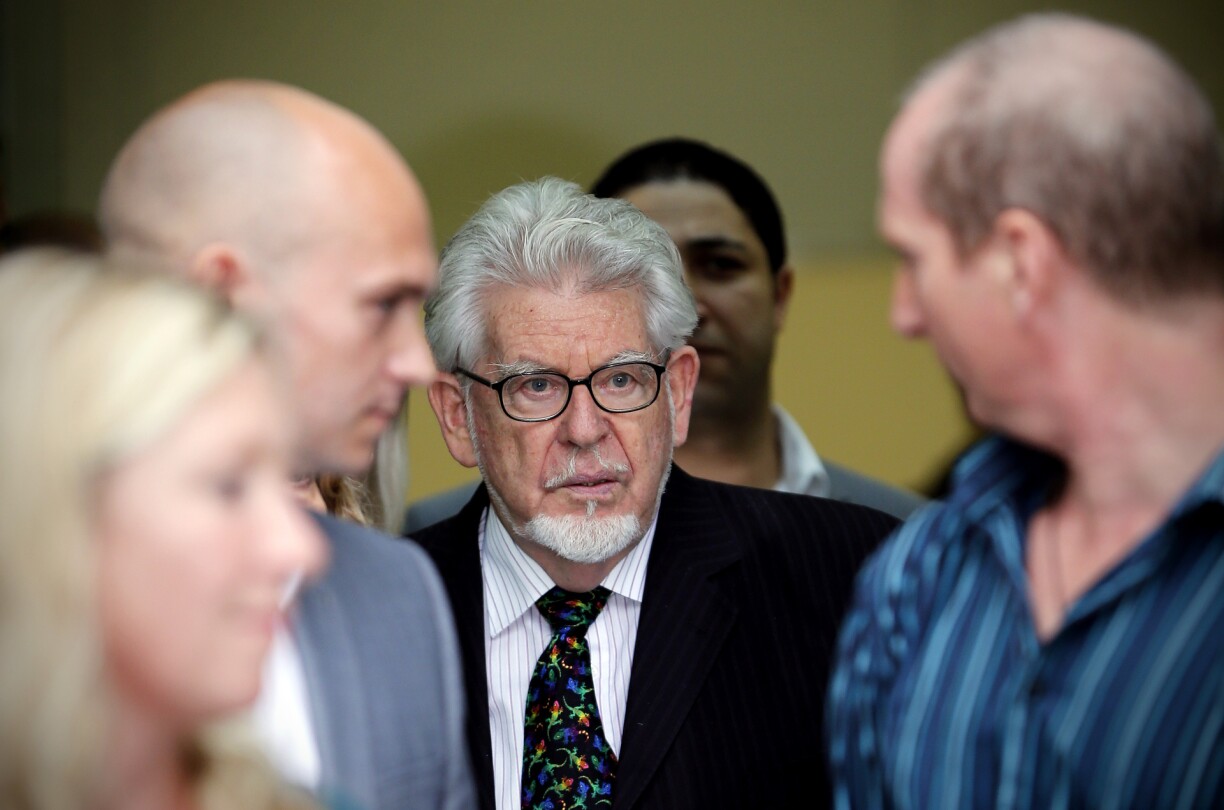 Rolf Harris leaves Westminster Magistrates' Court in central London on September 23, 2013, after attending a hearing over charges of nine counts of indecent assault on two girls aged under 16 and four counts of making indecent images of children.