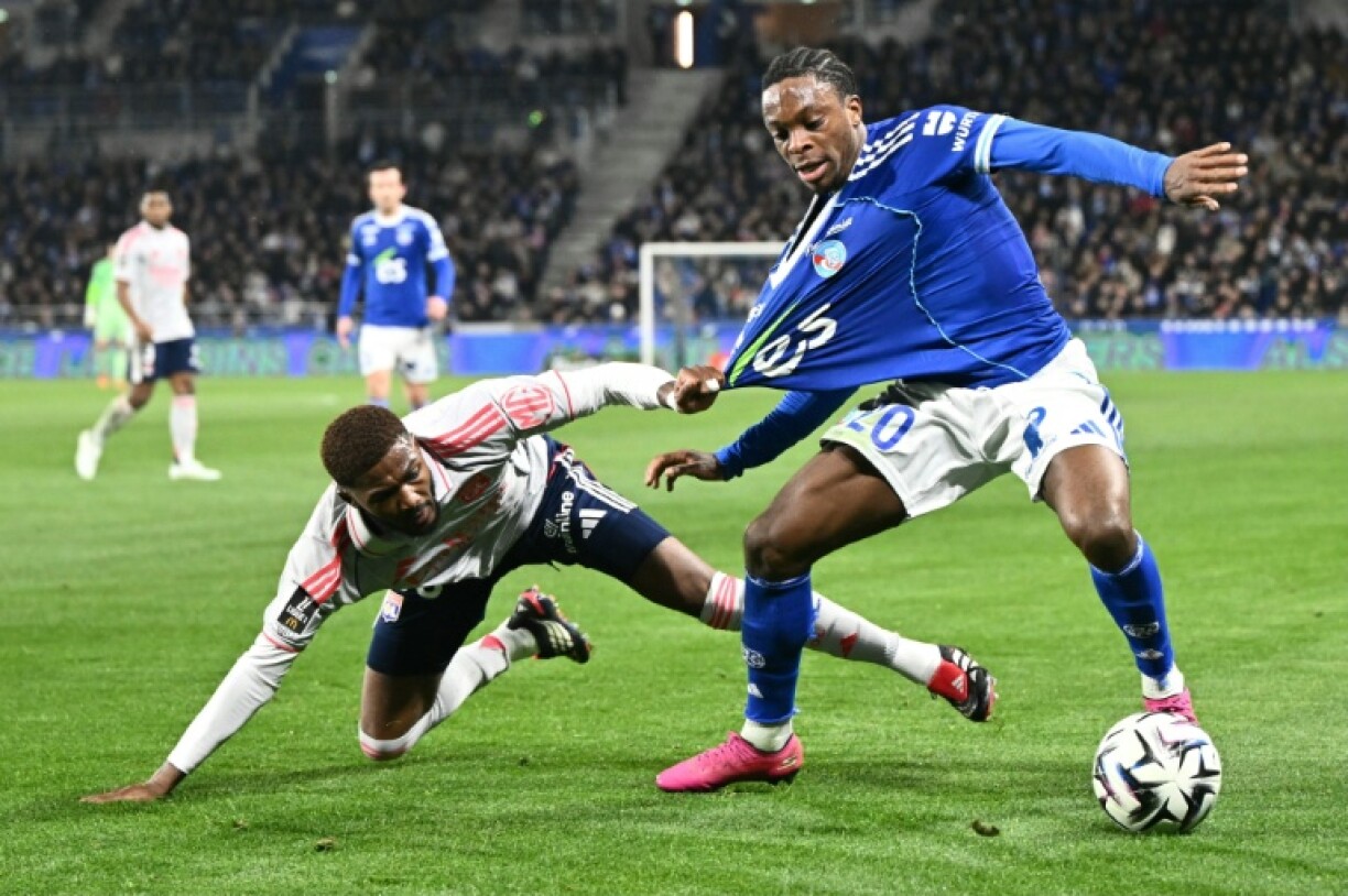 L'attaquant ivoirien de Strasbourg Martial Godo (D) aux prises avec le défenseur lyonnais Ainsley Maitland-Niles lors de la victoire alsacienne 3-1, le 22 février 2026 au Stade de la Meinau