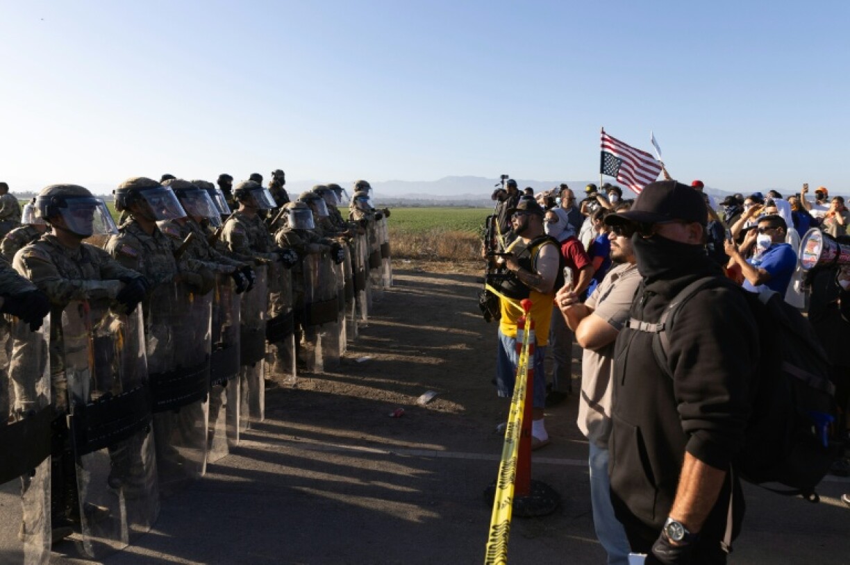 California National Guard troops face off with protestors during a federal immigration raid on Glass House Farms in Camarillo, California