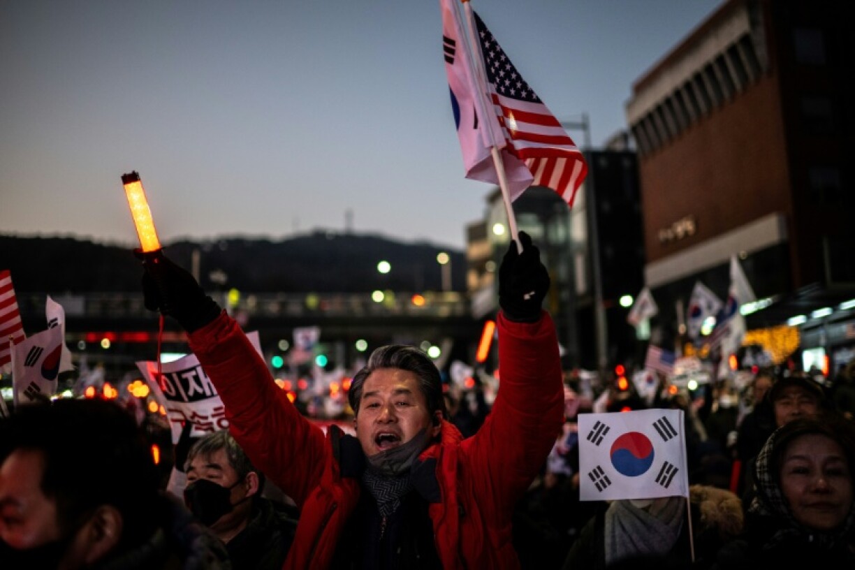 People wave US and South Korean flags during a rally to support impeached South Korea's President Yoon Suk Yeol