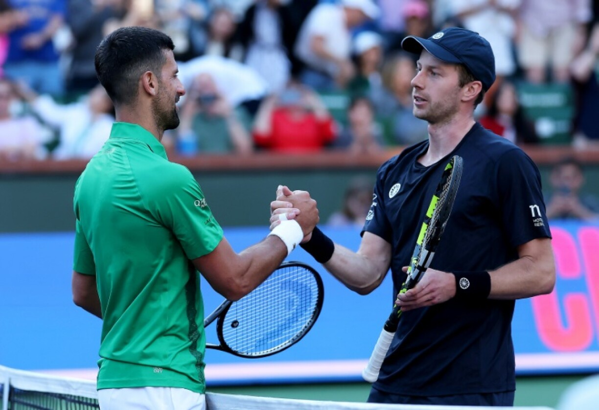 Five-time champion Novak Djokovic of Serbia shakes hands at the net after his three set defeat against Botic van de Zandschulp of the Netherlands in the second round at Indian Wells