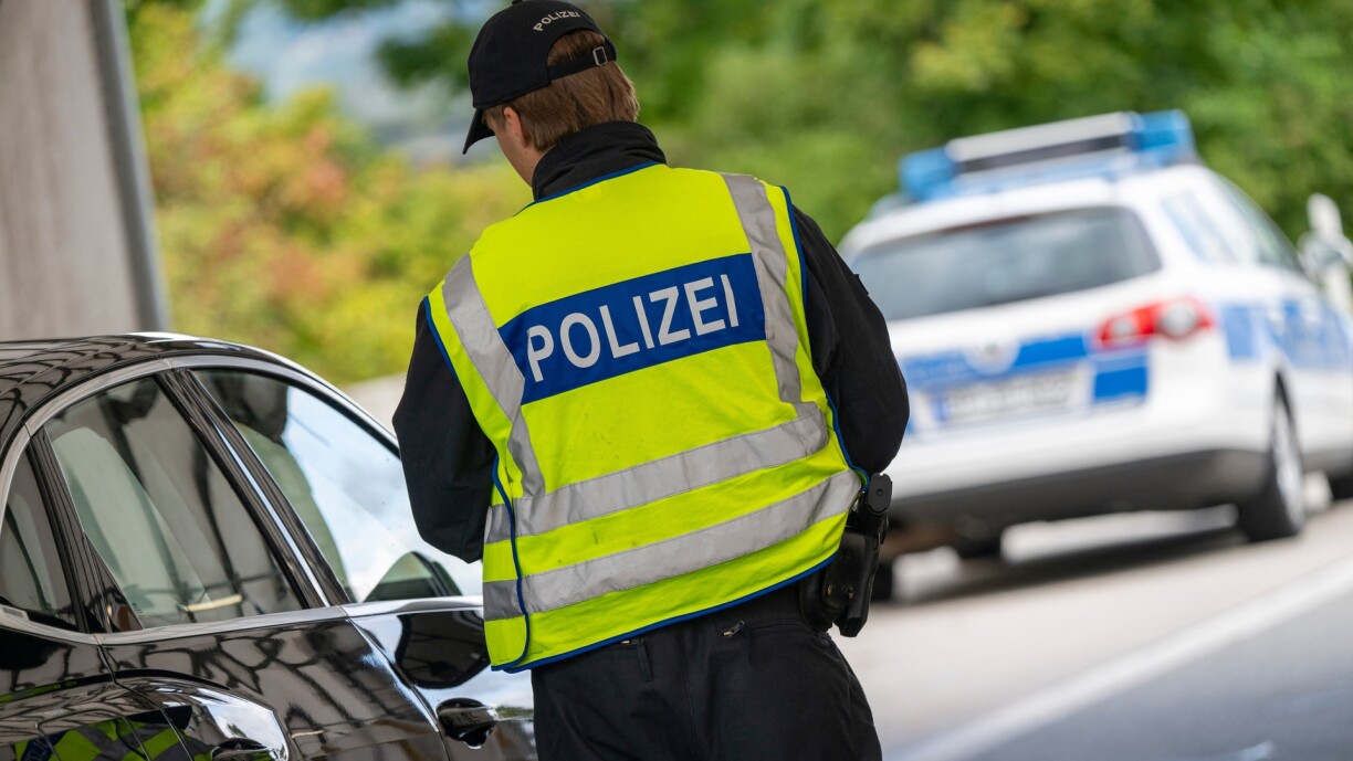 A police officer checks a car at the Kiefersfelden border crossing.