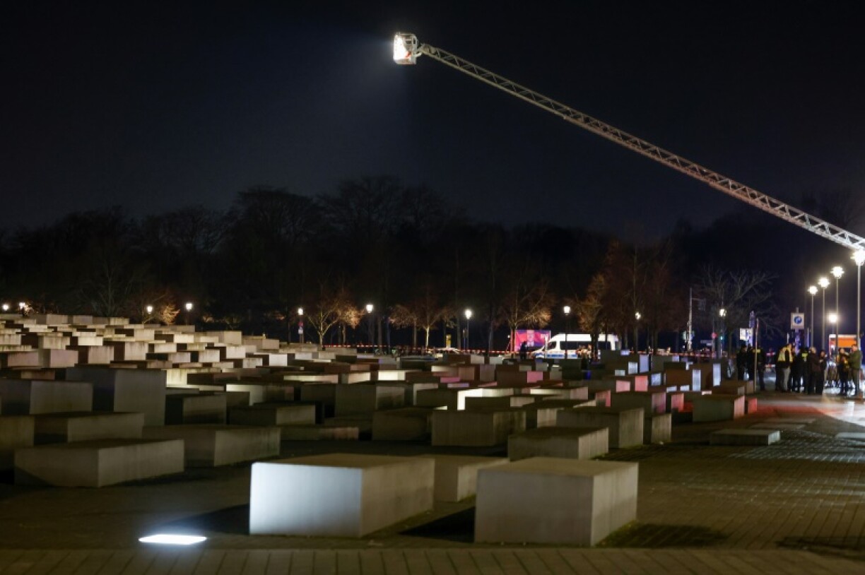 Emergency services look down from a crane over the Holocaust Memorial site after an attack that left a man badly injured