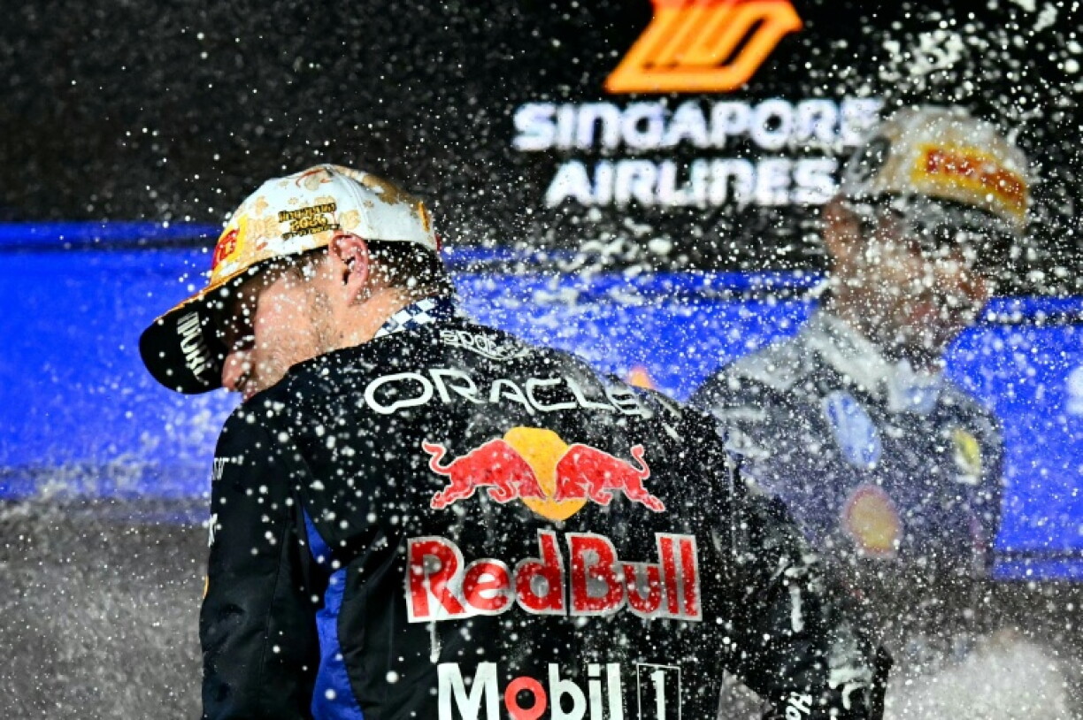 Max Verstappen (left) and Charles Leclerc celebrate on the podium after the Formula One Singapore Grand Prix