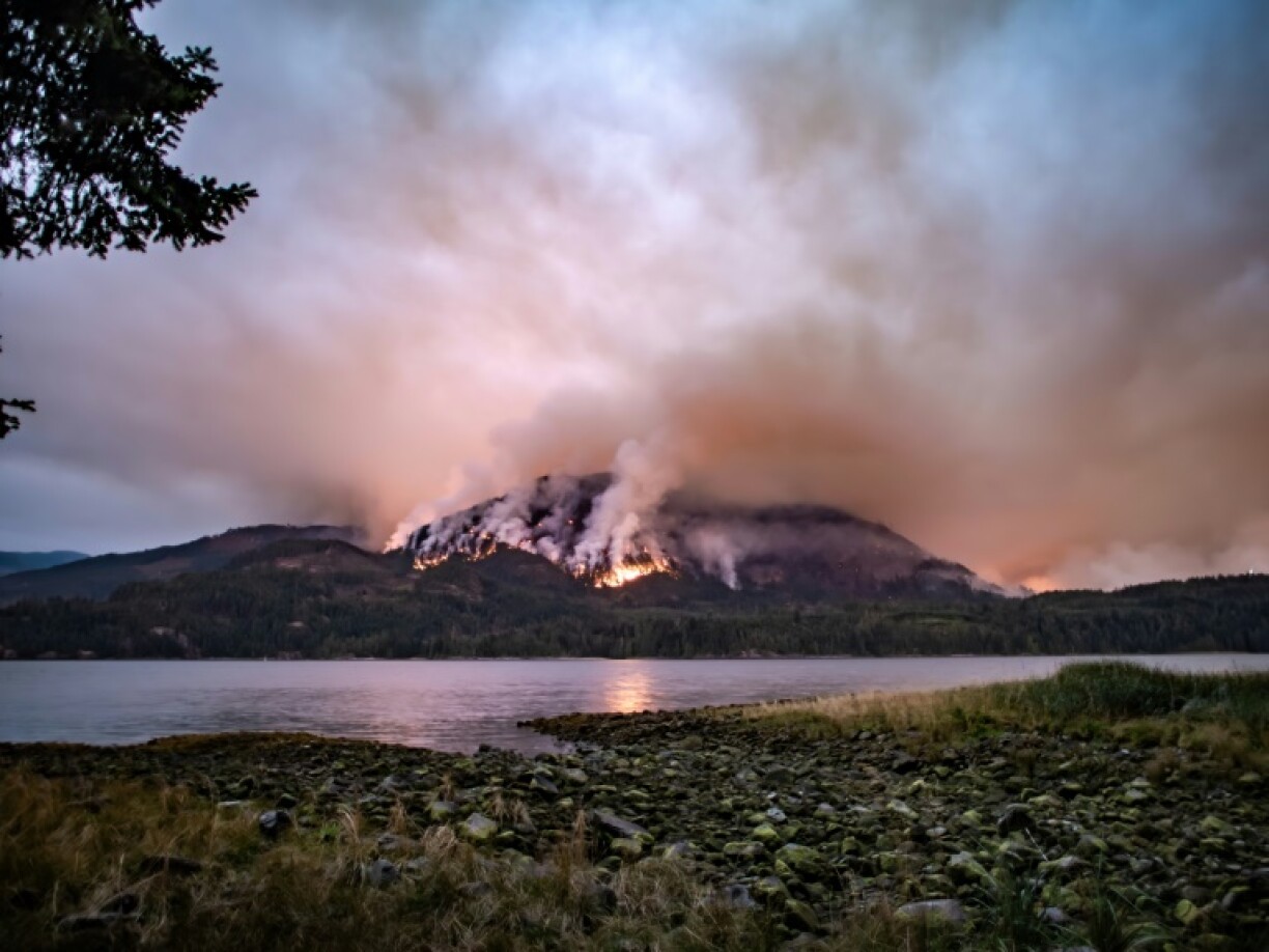 A wildfire burns on Mount Underwood near Port Alberni in western Canada on August 12, 2025