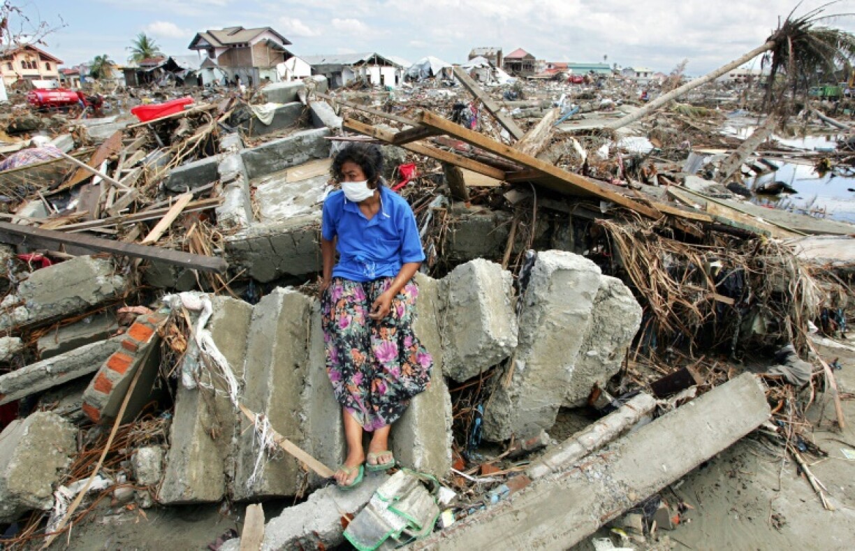 An Acehnese woman lingers at the ruins of her home in downtown Banda Aceh, Janaury 11, 2005