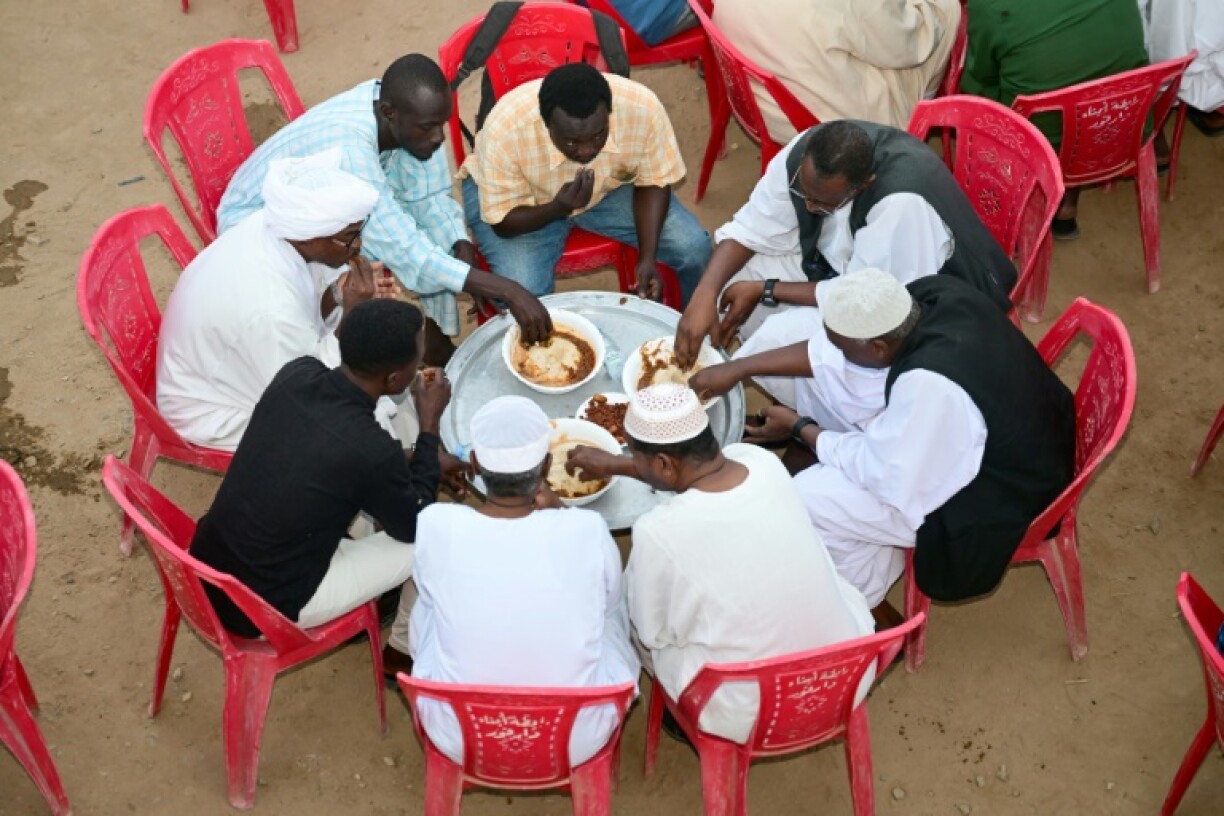 Sudanese, originally from the Darfur region, break their fast during a group iftar fast-breaking meal in the Muslim holy month of Ramadan, in Sudan's de-facto capital of Port Sudan