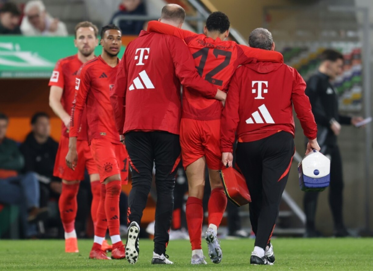 Bayern Munich midfielder Jamal Musiala is helped from the field with a hamstring injury