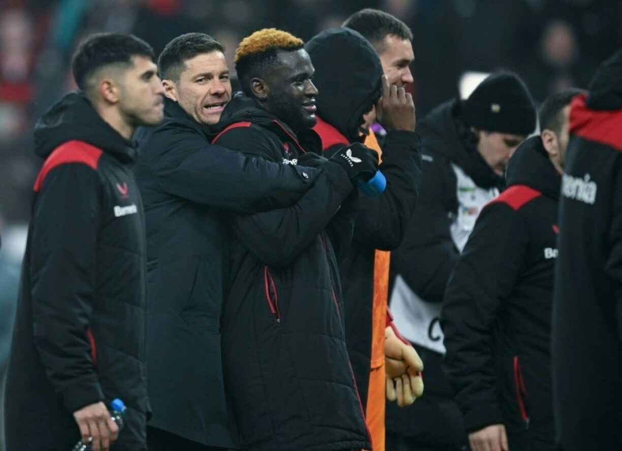 Bayer Leverkusen coach Xabi Alonso embraces striker Victor Boniface after he scored the winner in a 3-2 extra-time German Cup quarter-final win over Cologne