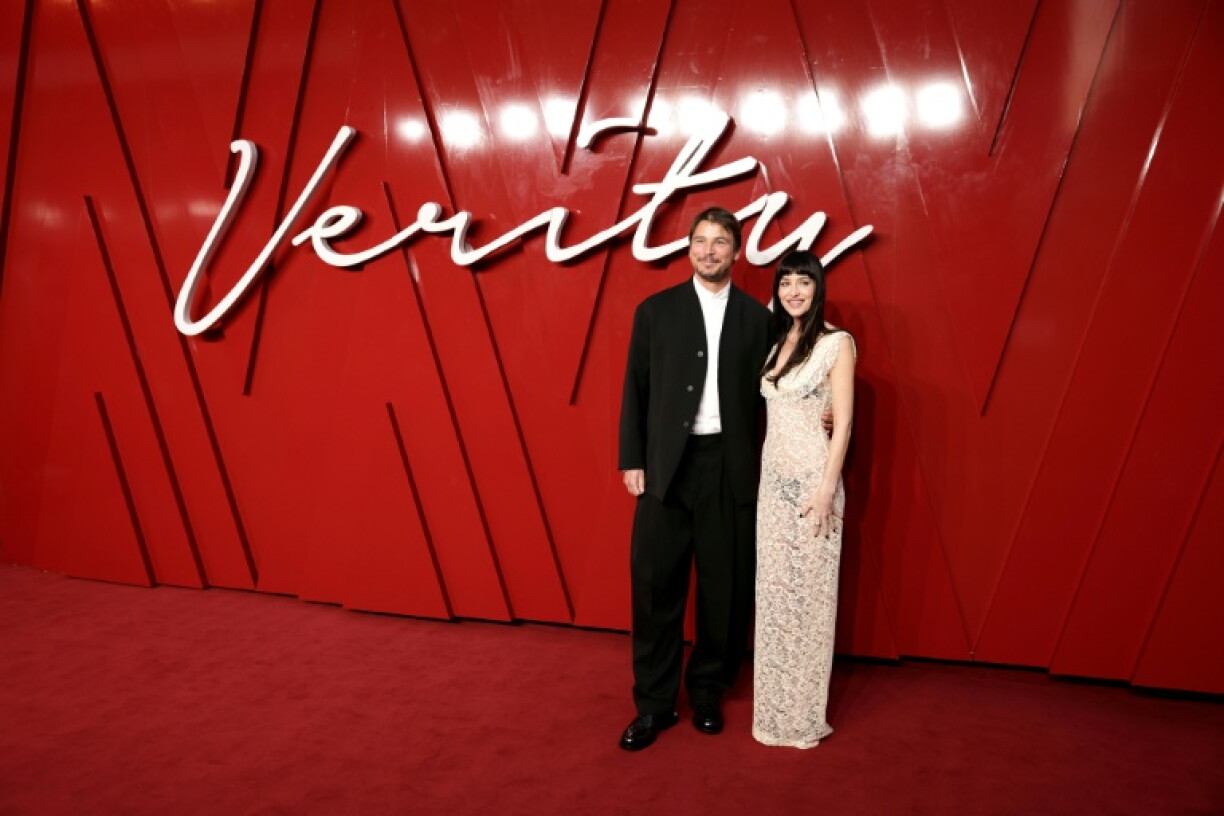 US actors Josh Hartnett and Dakota Johnson pose on the red carpet upon arrival to attend the UK Gala Screening of Verity, at the Curzon Mayfair, in London in September 2025