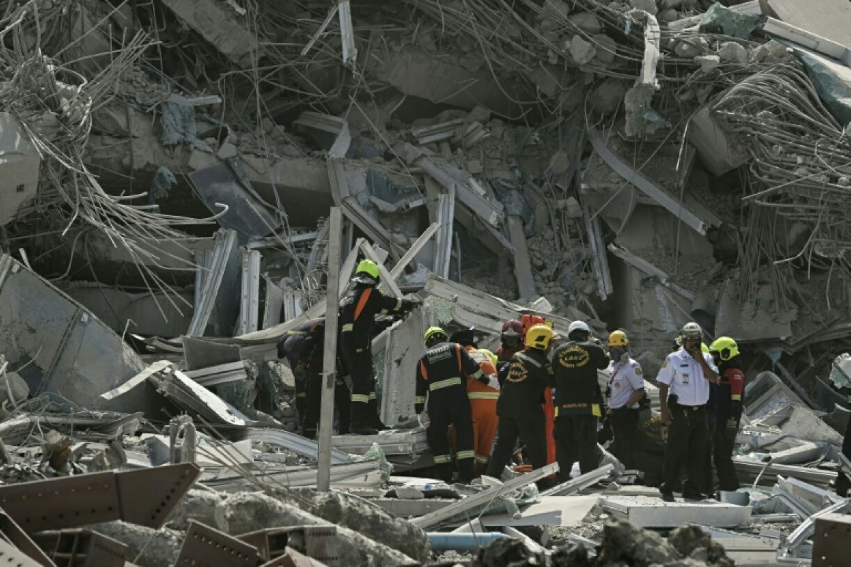 Rescue teams are seen at a construction site where a building collapsed in Bangkok