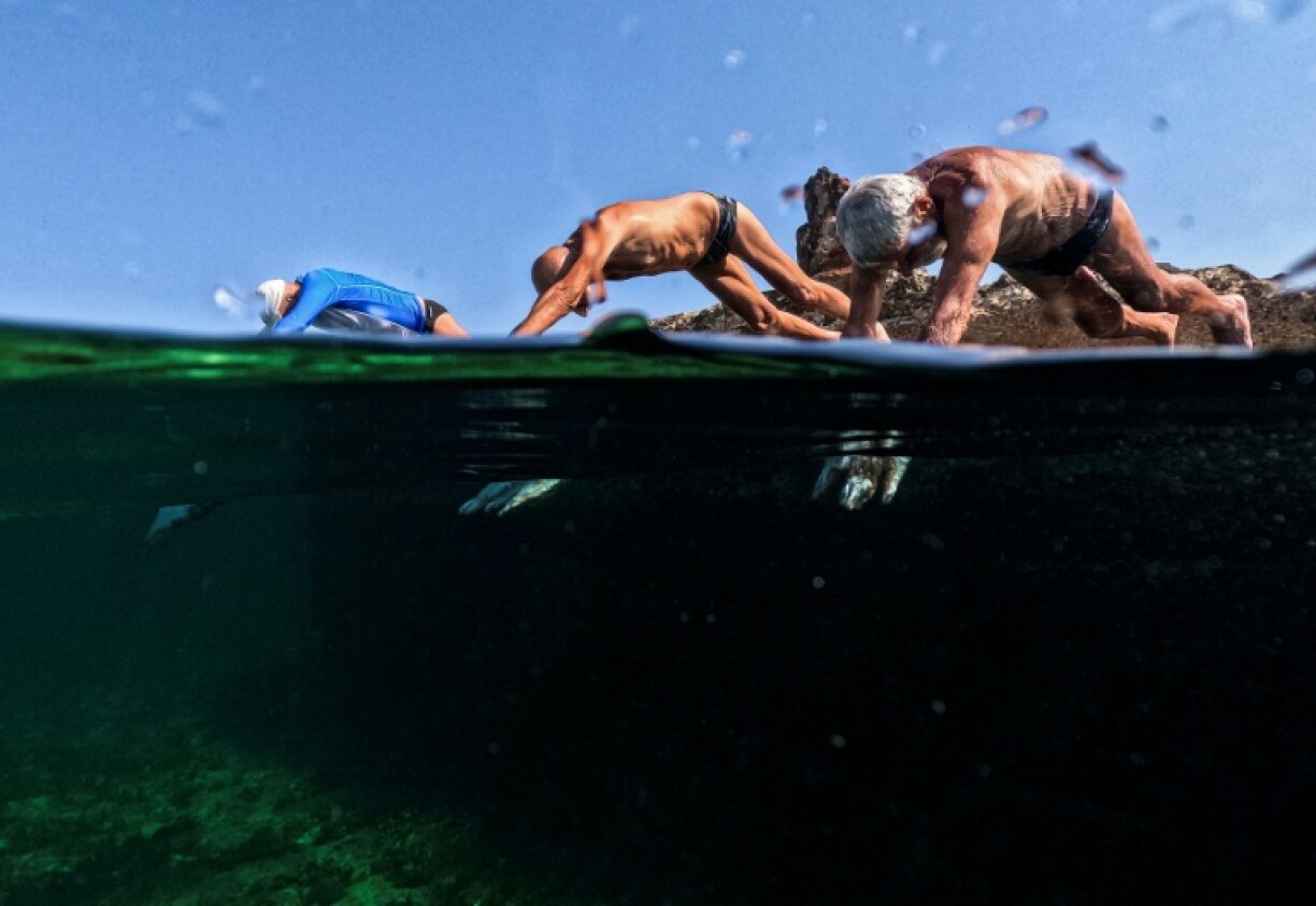 A group of Cubans in their seventies and eighties keep fit by swimming every day in the Caribbean