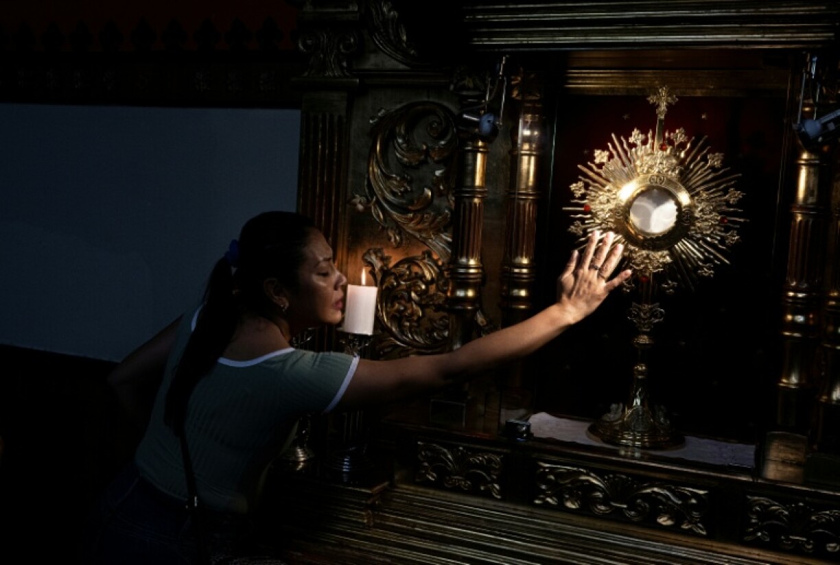 A woman prays at the Chiclayo's cathedral, northern Peru on May 9, 2025.
