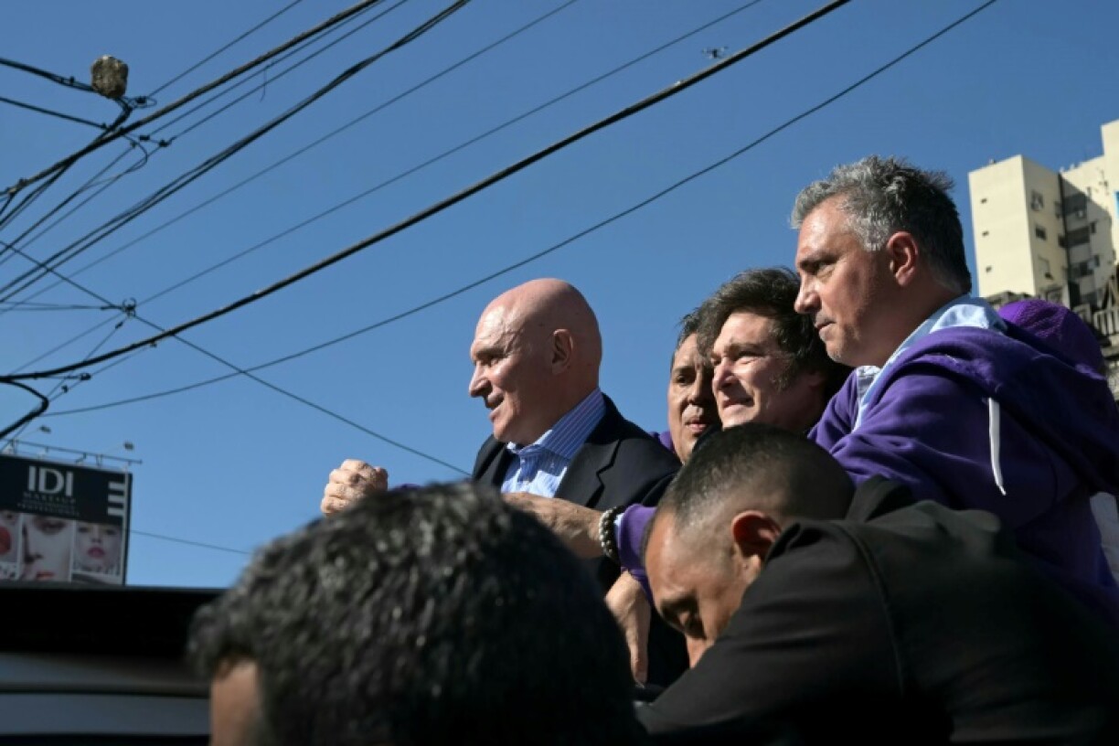 A stone, top left, thrown at Argentina's President Javier Milei while campaigning near Buenos Aires