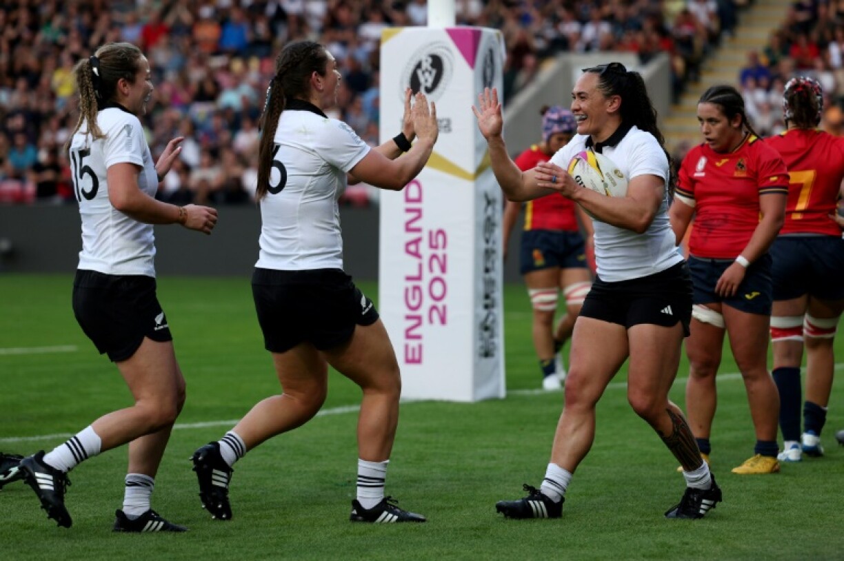 New Zealand's Portia Woodman-Wickliffe (R) celebrates after scoring a try during a 54-8 Women’s Rugby World Cup Pool C win over Spain in York