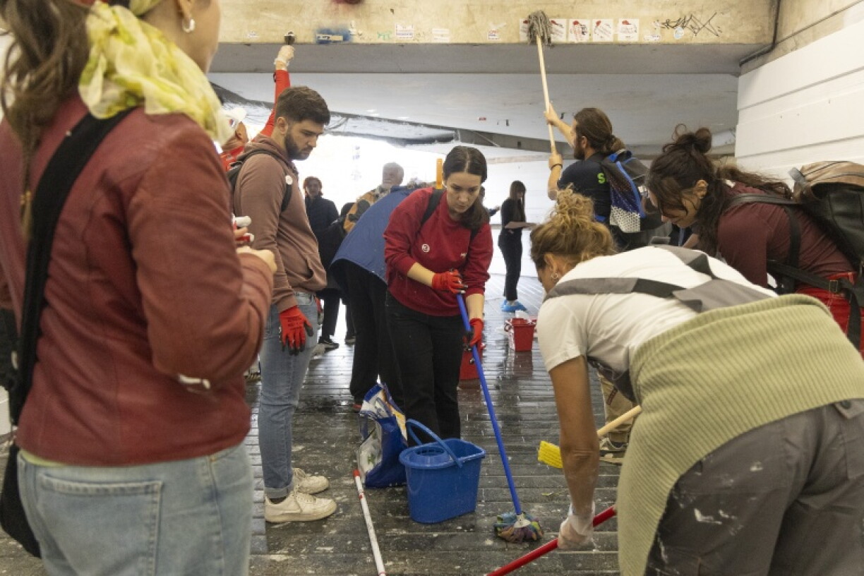 Belgrade residents paint over politically charged graffiti during a clean-up campaign in the Serbian capital on October 28, 2026, days after a student-backed list won the country's snap parliamentary elections. The campaign, backed by the student-led movement, aims to remove graffiti, rubbish and other traces of nearly two years of political protests and restore public spaces across the city.